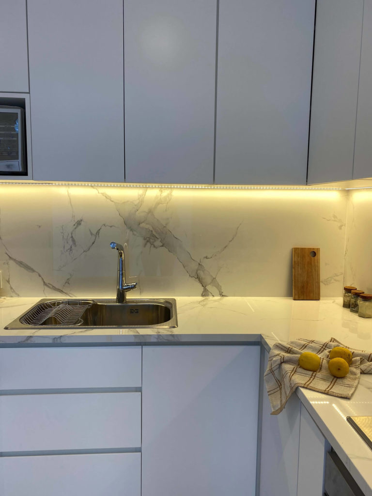 Detalle de mesada y revestimiento de fondo en Dekton calacatta natura.